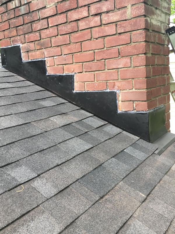 Step flashing on a brick chimney