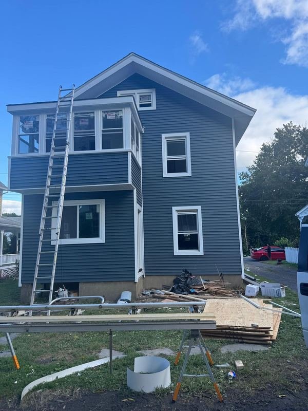 Home with new roof, ladders on site