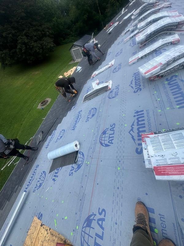 Crew installing Atlas Summit synthetic underlayment