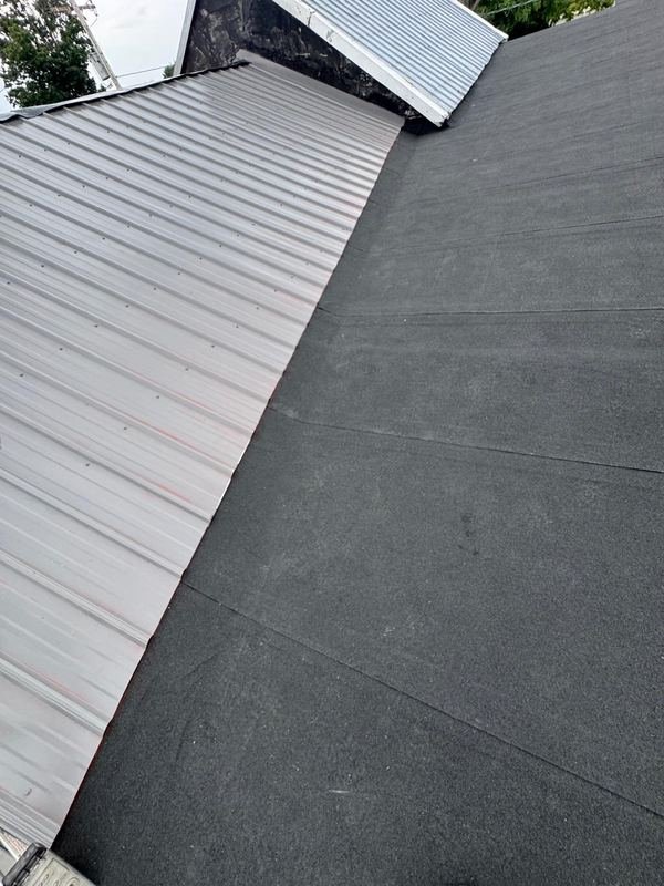 Metal roof meeting a low-slope section
